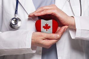 Canadian doctor holding heart with flag of Canada