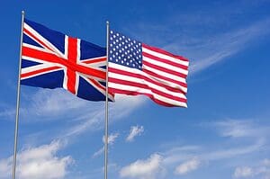 United Kingdom and USA flags over blue sky